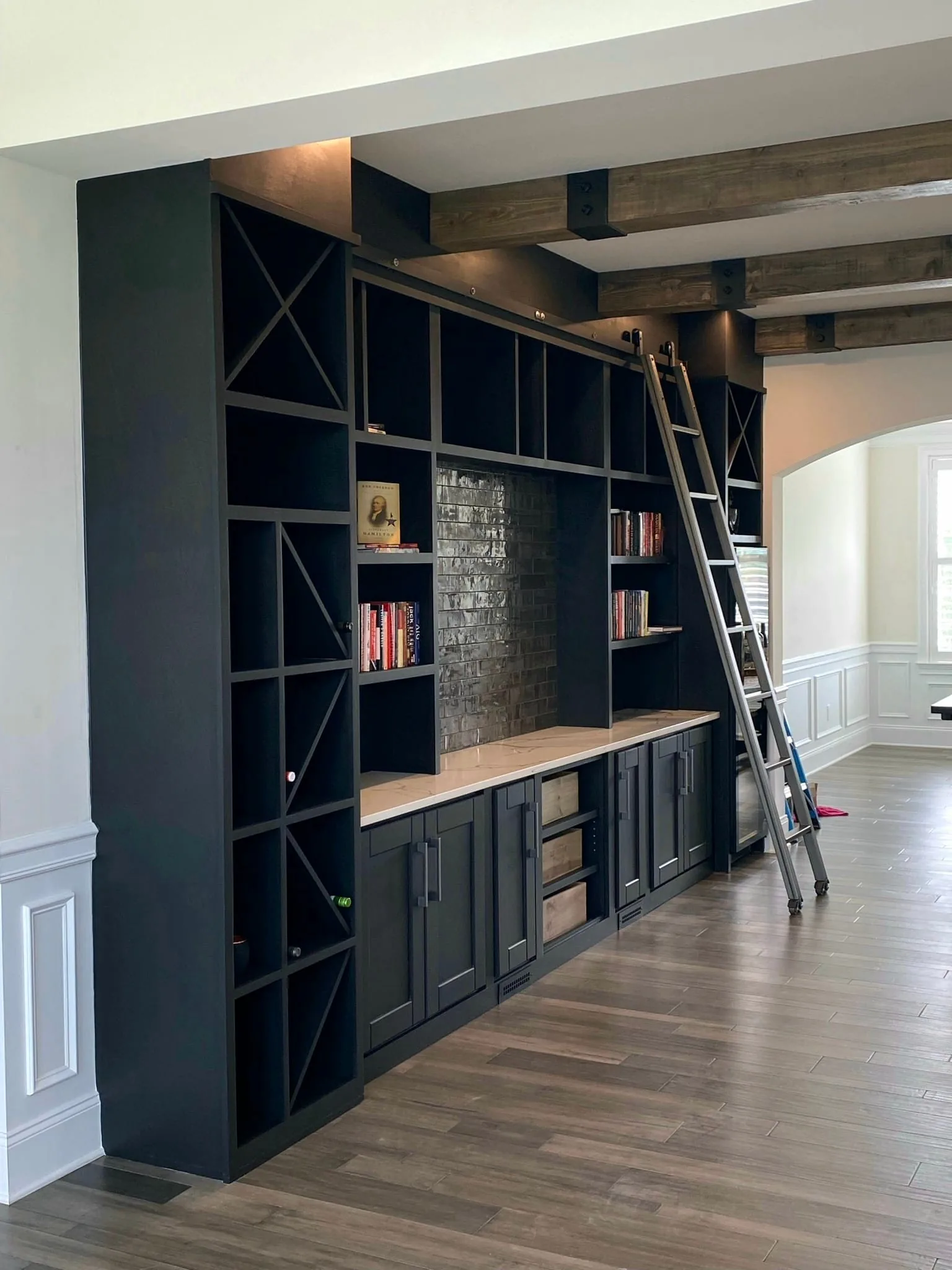 Navy Library with Rolling Ladder — custom carpentry by Custom Interiors & Remodeling